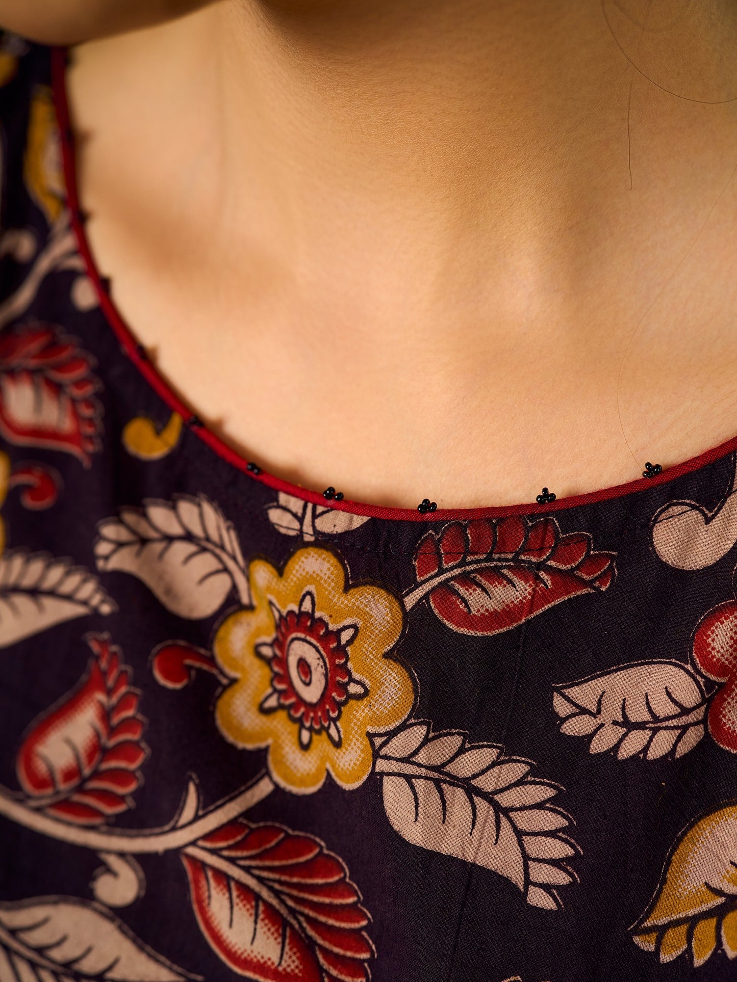 Mustard Kalamkari dress with an asymmetrical yoke and puffed sleeves.