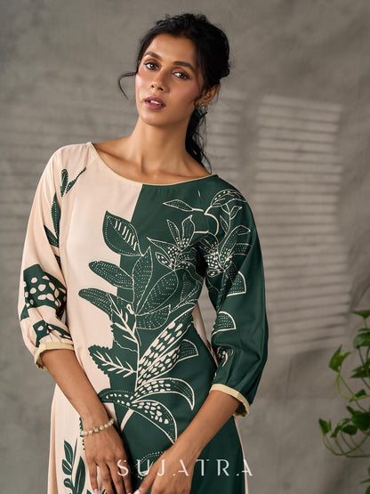 Bottle green and beige half and half dress with raglan sleeves and transitioning floral motifs.