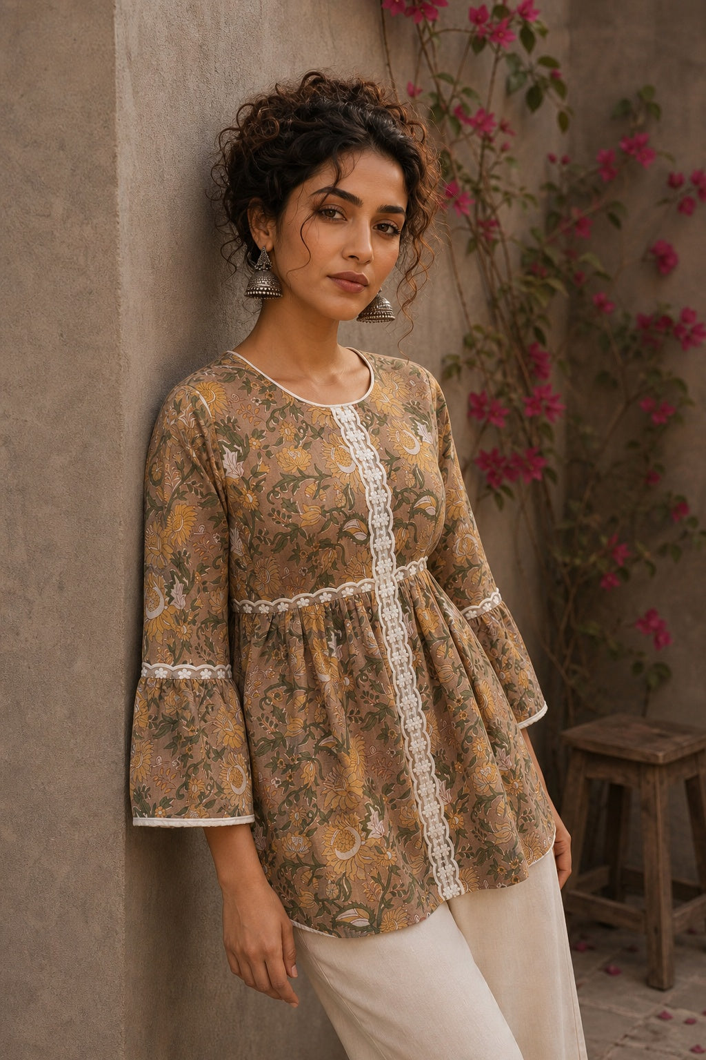 Romantic peach Jaipur floral top adorned with scalloped lace, gathered sleeve hems, and playful tie-knot accents.