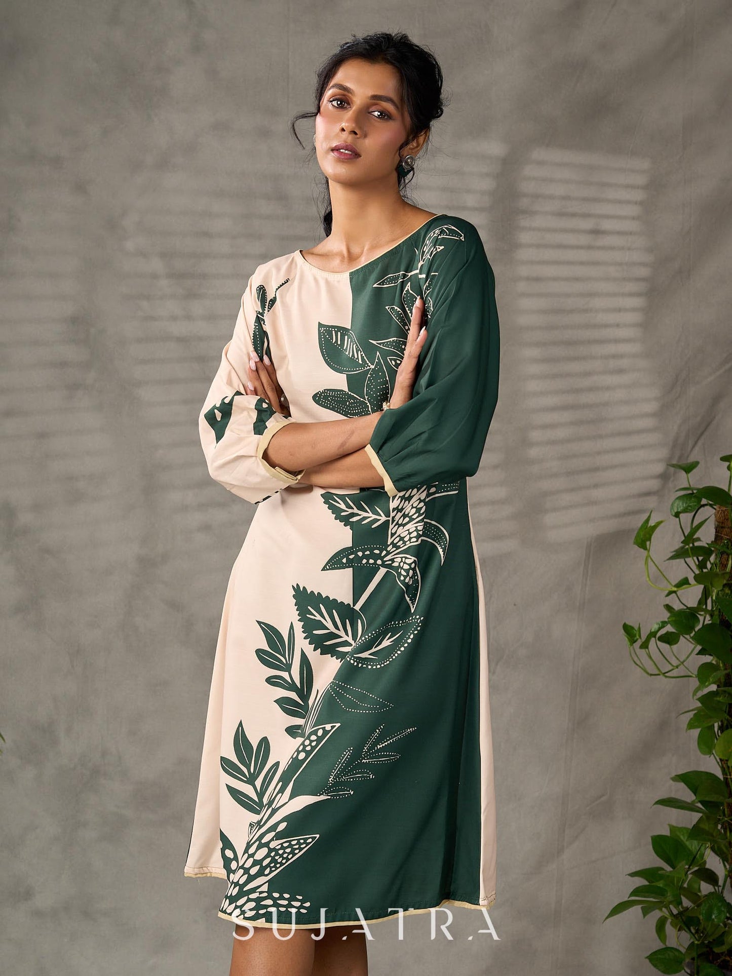 Bottle green and beige half and half dress with raglan sleeves and transitioning floral motifs.