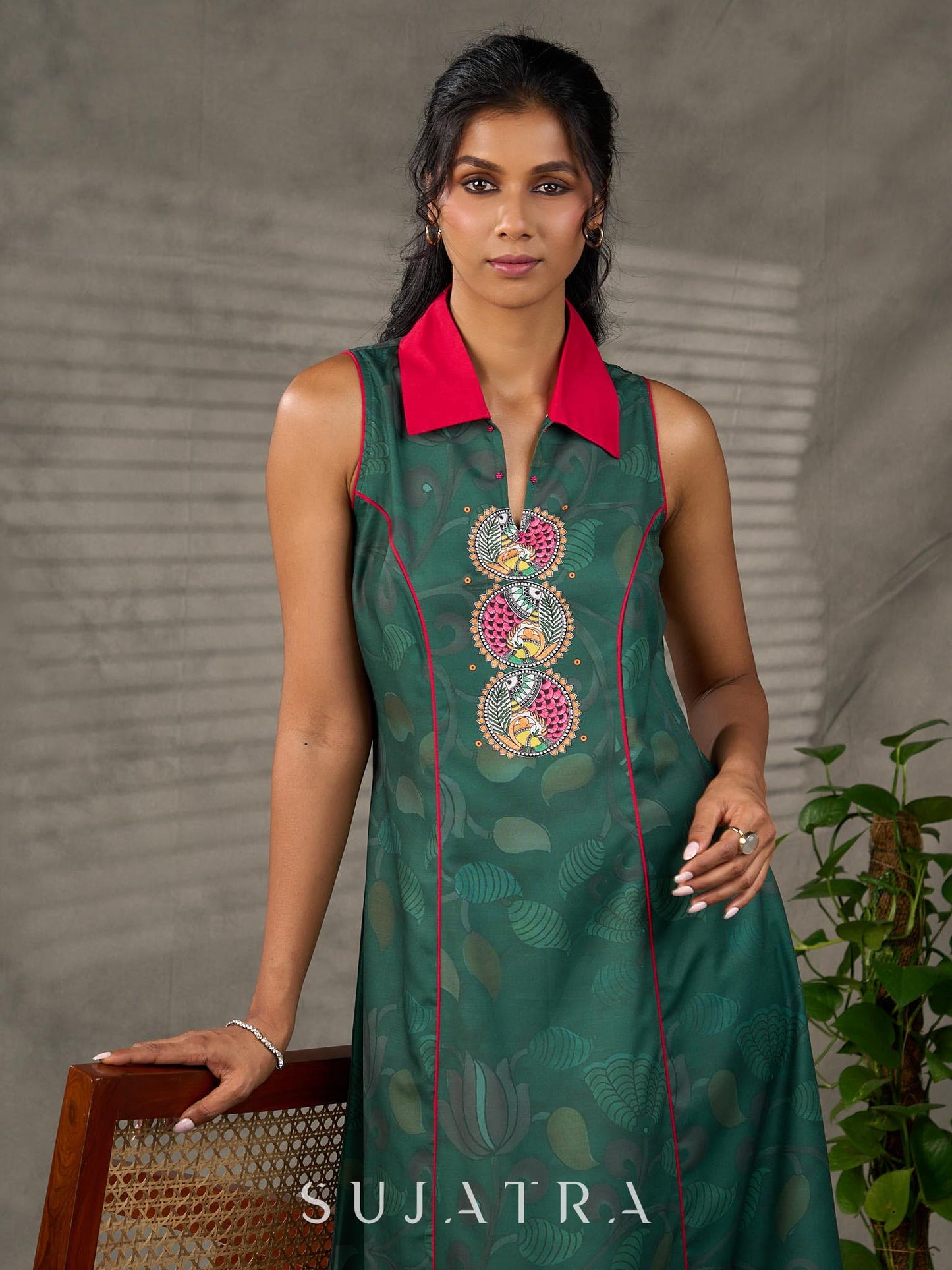 Bottle green Madhubani printed dress with vibrant magenta accents.