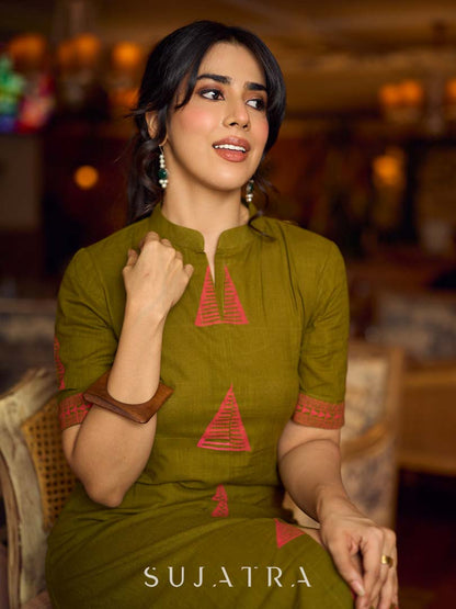 Gorgeous olive dress with pink abstract triangle hand block prints placed at the centre, sleeves, and back, featuring a mandarin collar and half sleeves for a refined, contemporary look.