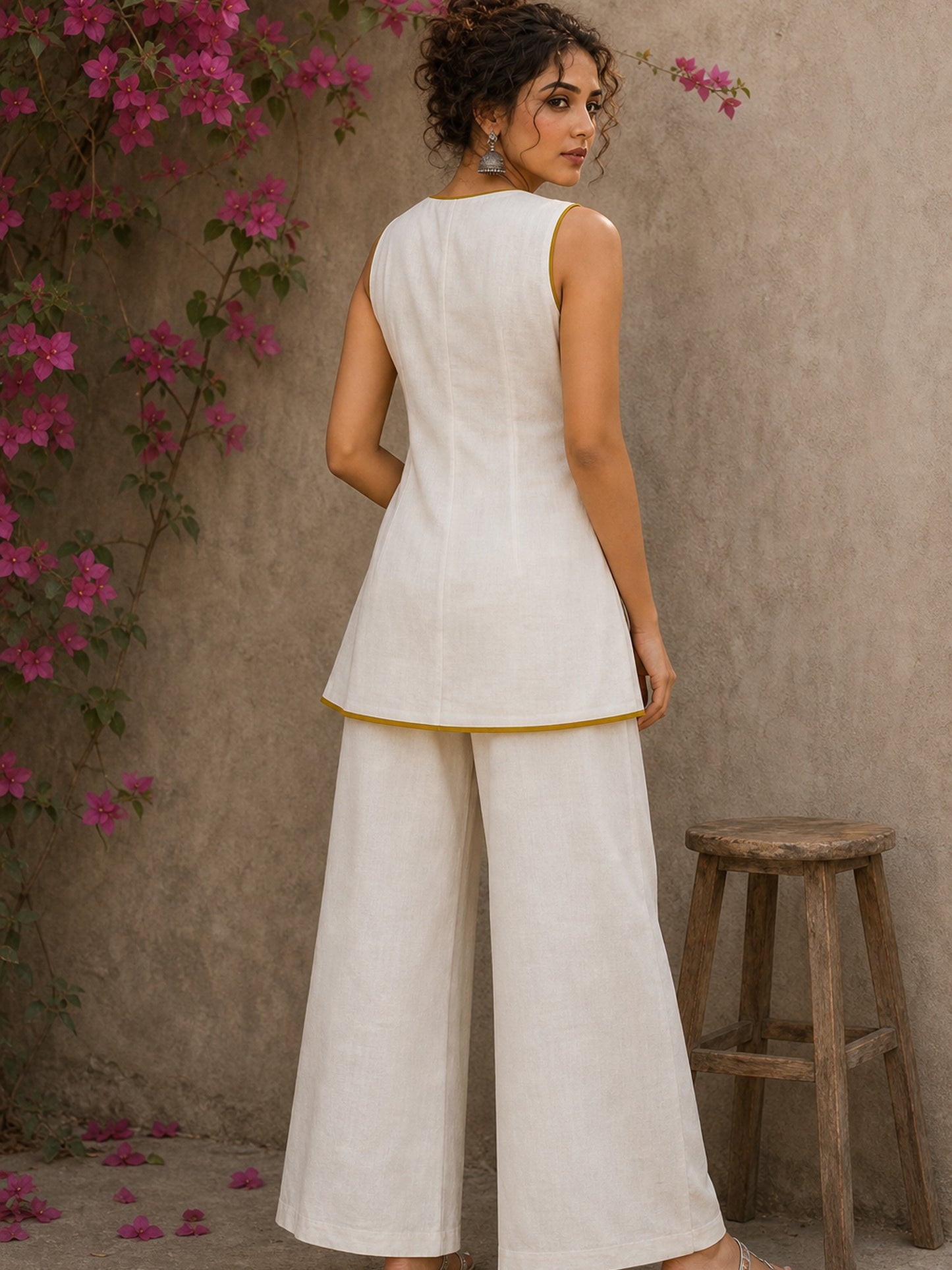 Charming white and mustard sleeveless wrap top featuring a distinctive Block print pattern, elegant mustard piping, and a graceful, contemporary, artisan-inspired tailored silhouette.