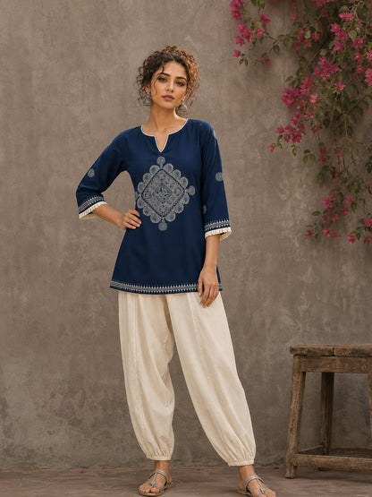Captivating navy top adorned with a bold, rhythmic block print design, pleated sleeve detailing, and a versatile cut.