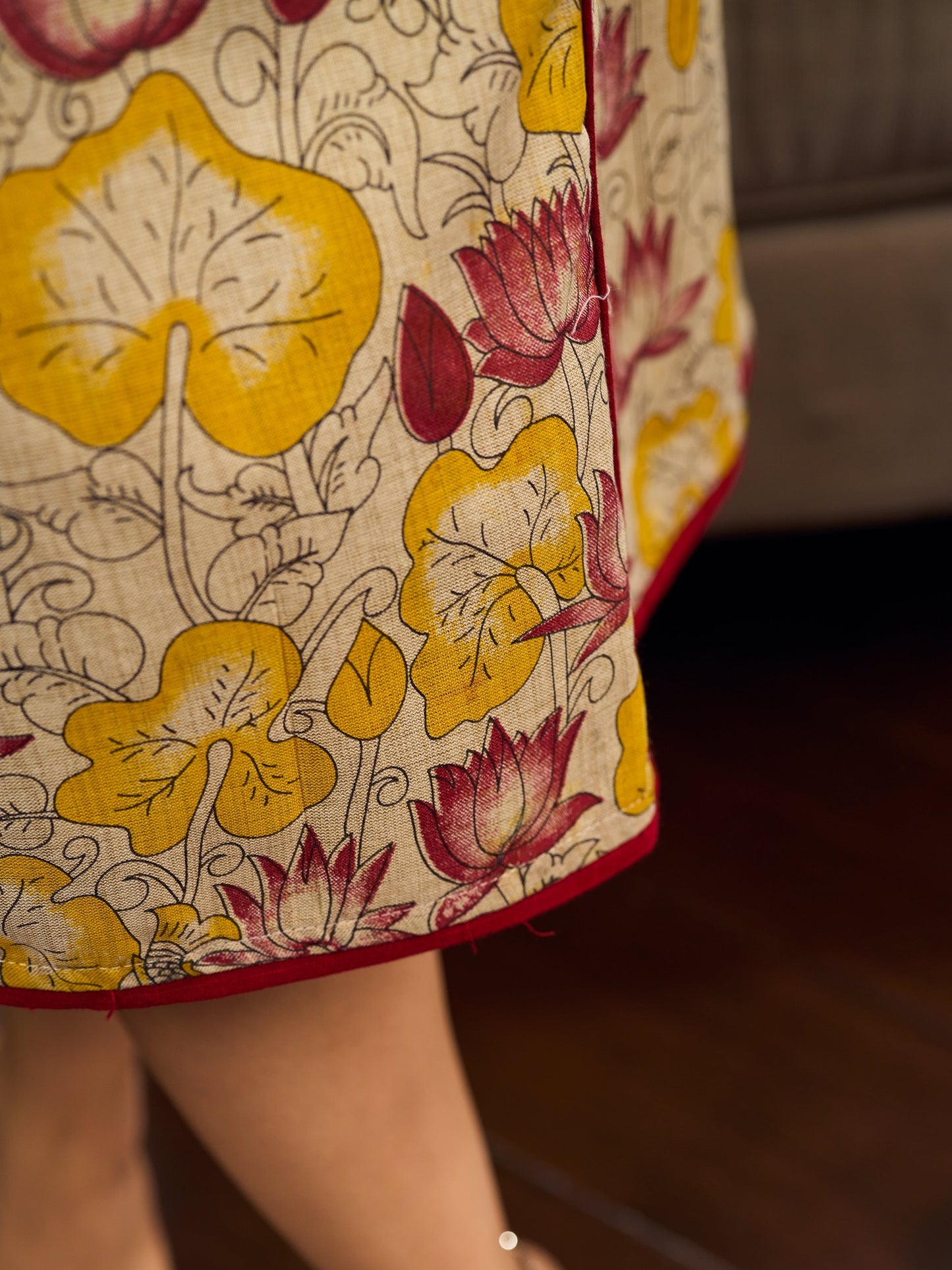 Elegant cream and maroon Madhubani dress featuring sophisticated wavy pintuck flap detailing.