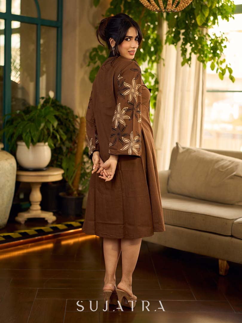 Brown block print dress with floral block printed flared sleeves, black tie-up neckline, and contrast black accents for an effortless, elegant everyday look.