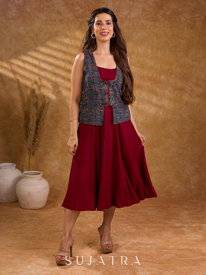 Handcrafted Ajrakh sleeveless jacket featuring front flaps, maroon detailing, breathable fabric, and a contemporary ethnic fusion appeal.