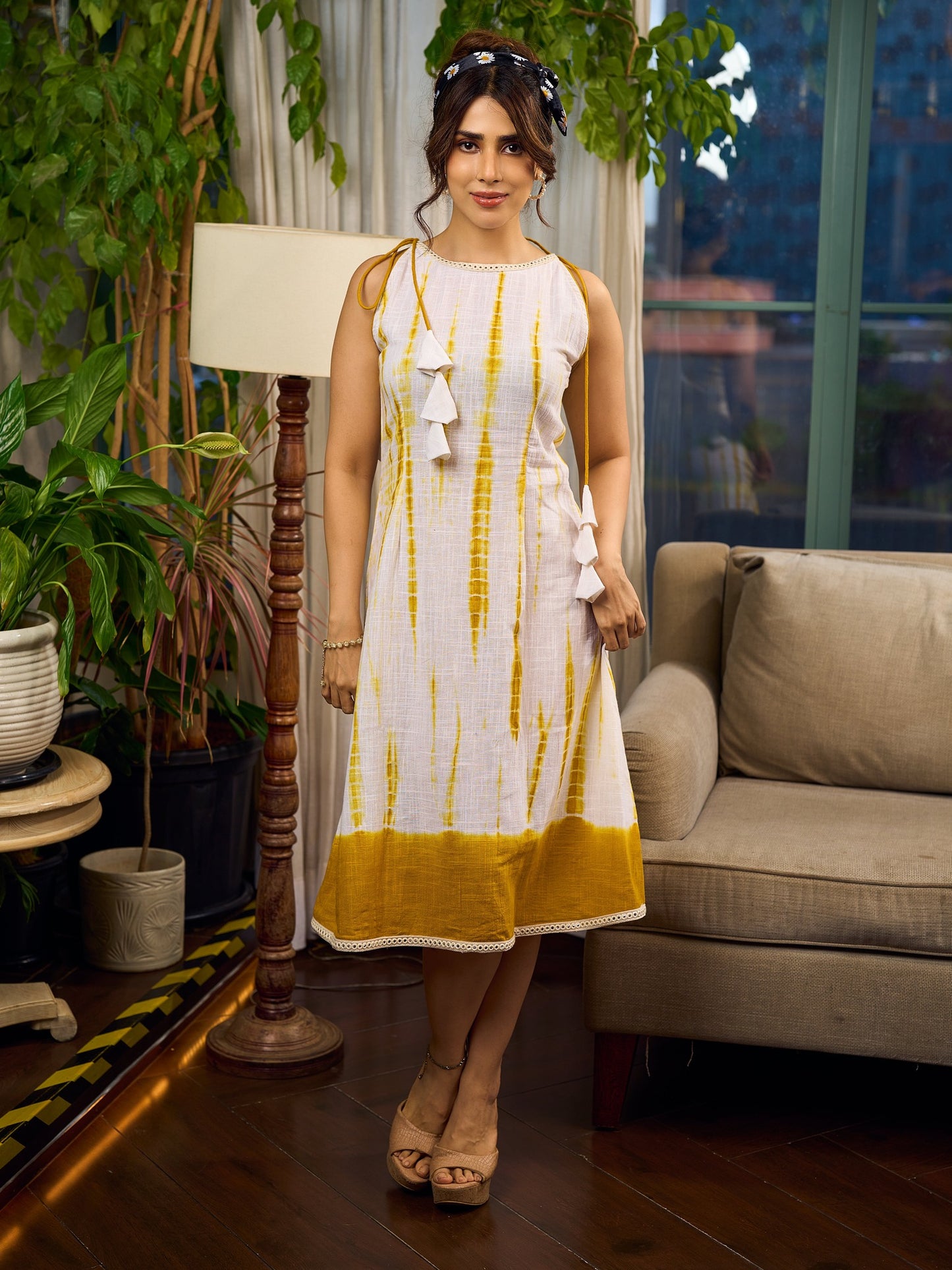 Sunlit ivory tie-dye dress with mustard accents and playful tassel shoulder detailing.