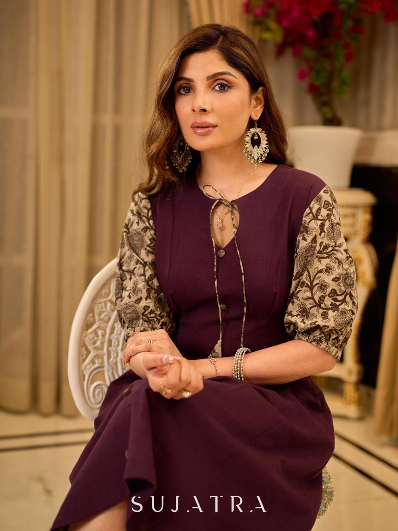 Playful purple cotton dress showcasing floral puff sleeves and box pleats released from the dart for soft volume and flow