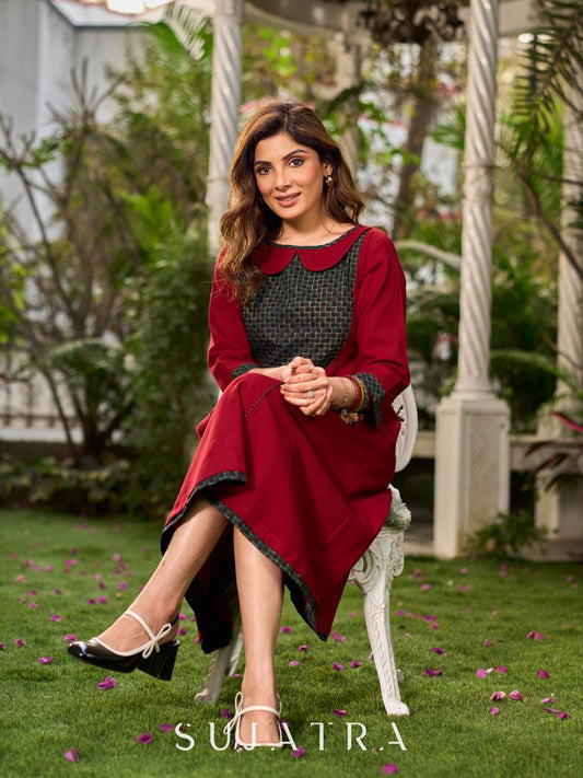 Chic maroon dress featuring a contrasting teal neck patch with charming Peter Pan collar details