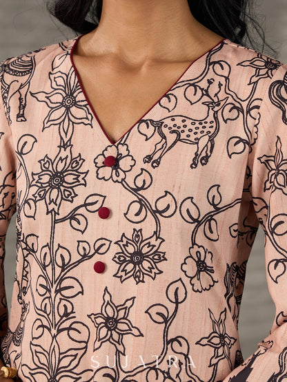 Beige traditional printed dress with rich maroon accents.