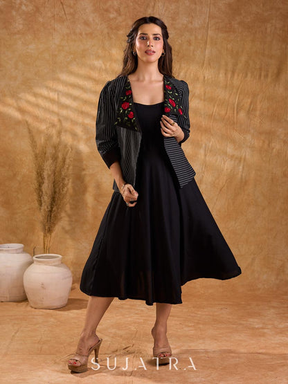 Exquisite black Ikat jacket with offset collar flaps and detailed red floral vine embroidery, delivering a sculpted, high-impact silhouette with refined presence for corporate styling.