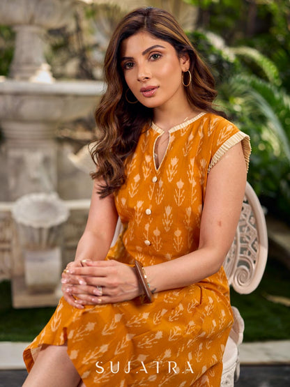 Statement mercerised mustard Ikat dress elevated with drop-shoulder styling, pleated neckline and sleeves detailing featuring soft box pleats for ease and movement