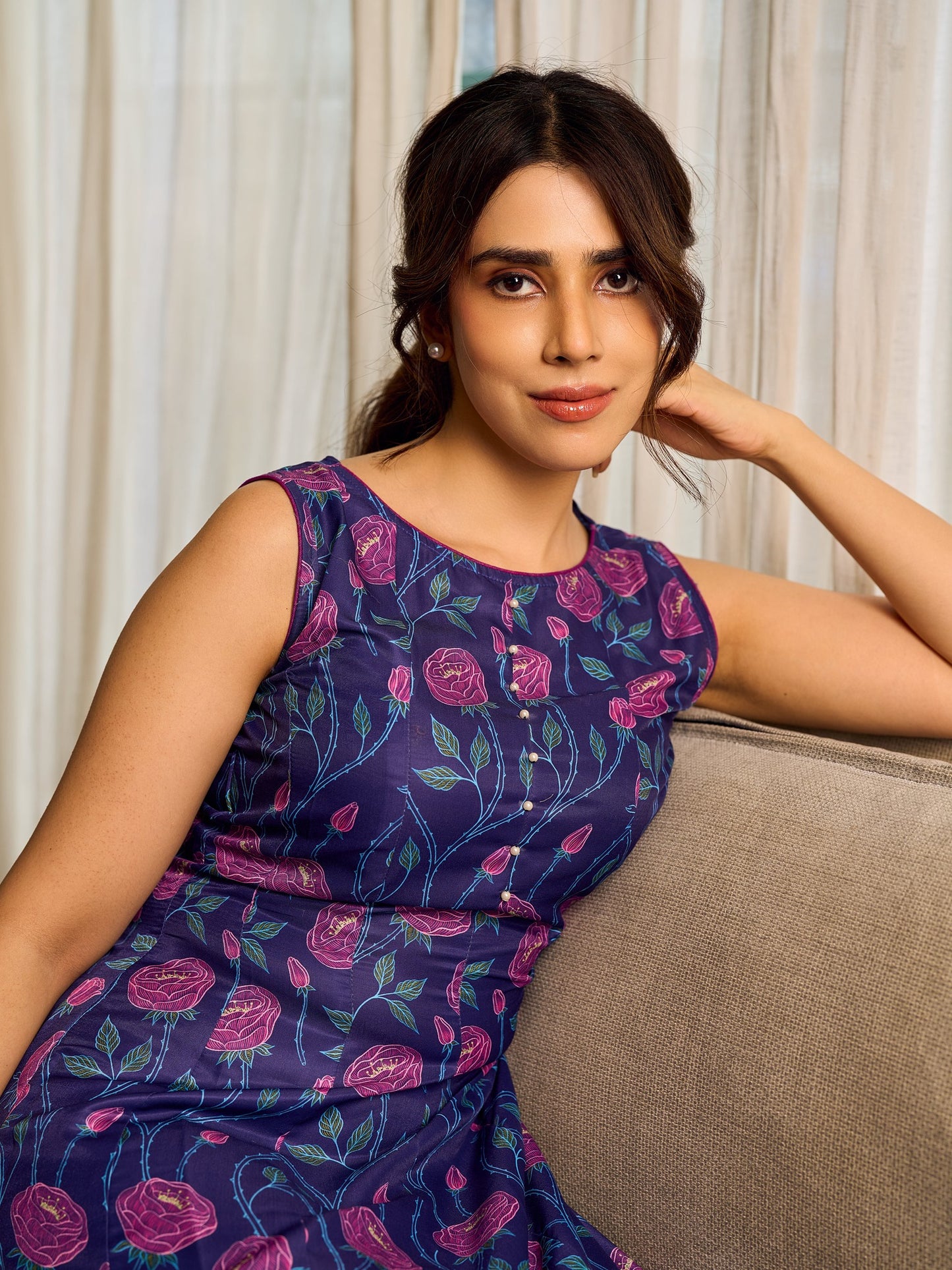 Enchanting purple panel dress featuring vibrant magenta floral prints, a sleeveless silhouette, and a graceful fit-and-flare design for timeless elegance.