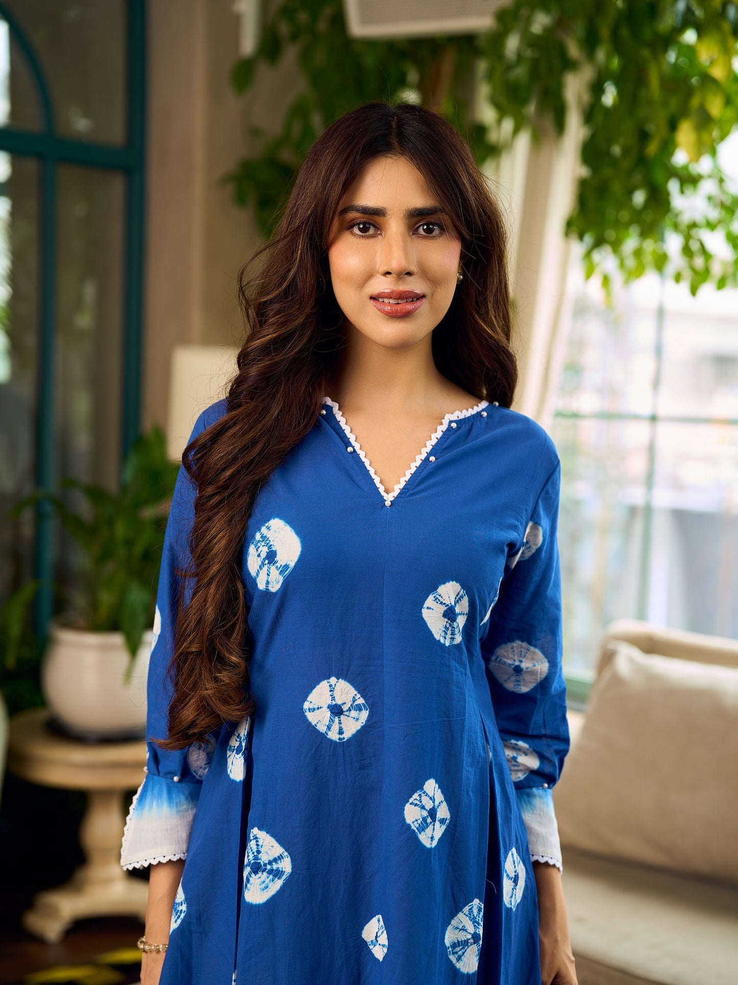 Refreshing cobalt blue shibori tie-dye dress with ivory accents and delicate lace-trimmed neckline.