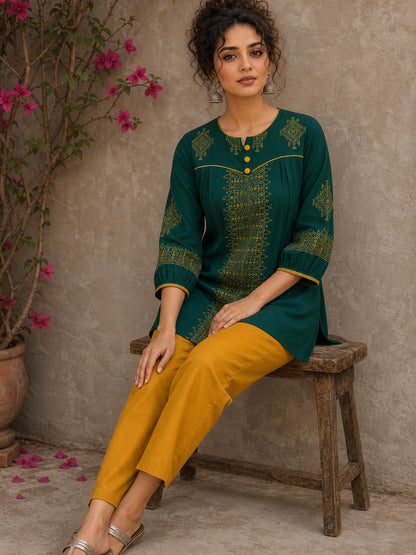 Enchanting bottle green tunic featuring a refined, rhythmic Block print motifs, vibrant mustard accents, and a graceful aesthetic.