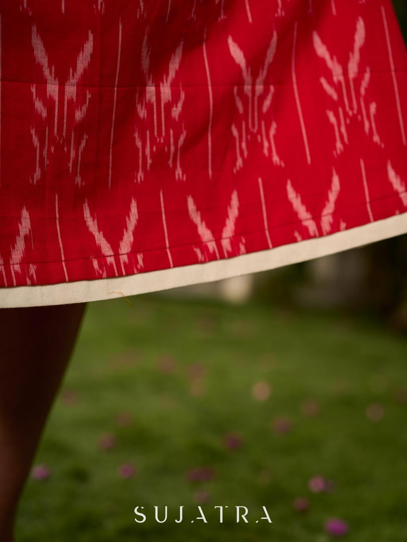 Statement red Ikat halter-neck dress accented in white, designed with a box pleat at the neckline for fluid drape.