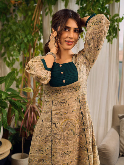 Artisanal beige Madhubani dress featuring intricate motifs, a contrasting green yoke, and refined accents.