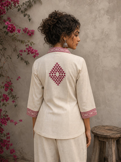 Vibrant ivory hand block print shirt featuring geometric motifs, magenta accents, and a contemporary silhouette inspired by traditional craftsmanship.