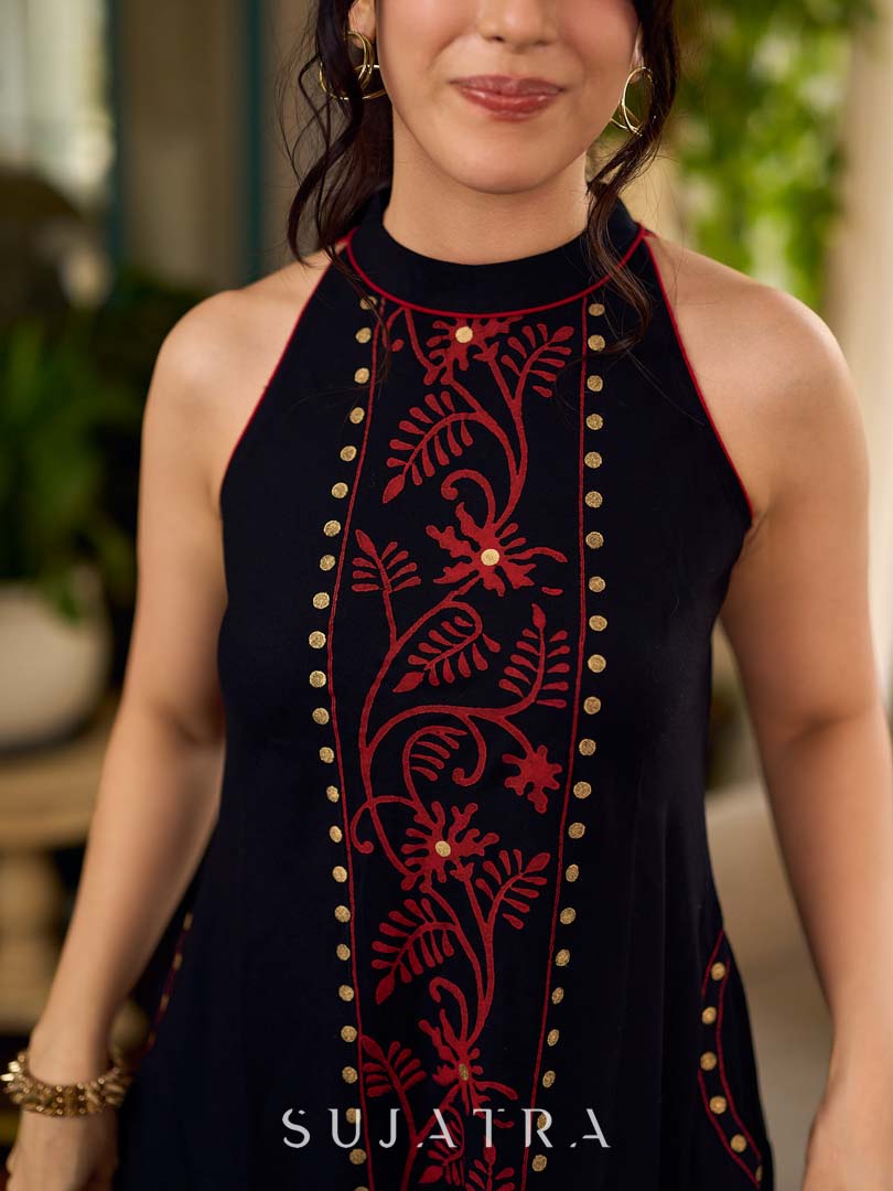 Black bias-cut block print halter dress with a red jaal hand block printed front panel, golden print detailing, and red accents for a striking, elegant statement look.