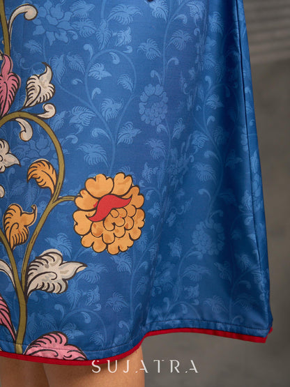 Indigo Kalamkari printed dress with vibrant red and mustard accents.