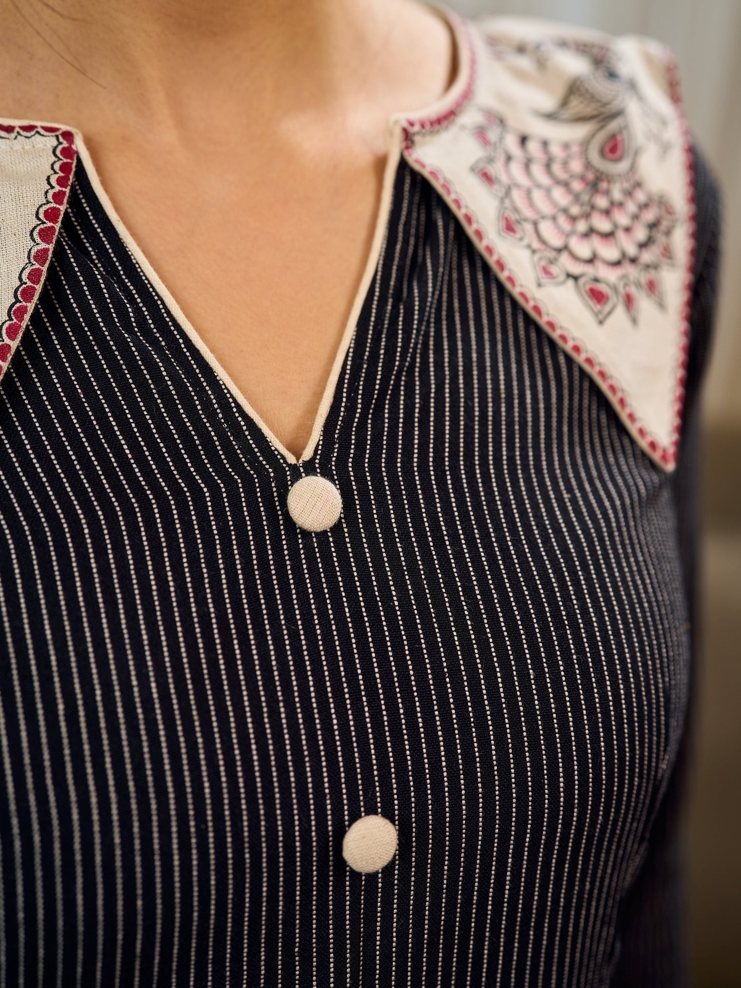Timeless black stripes accented with exquisite hand-painted Madhubani on collars and cuffs