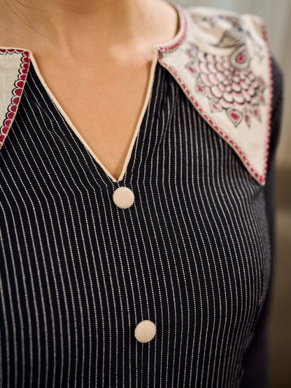 Timeless black stripes accented with exquisite hand-painted Madhubani on collars and cuffs