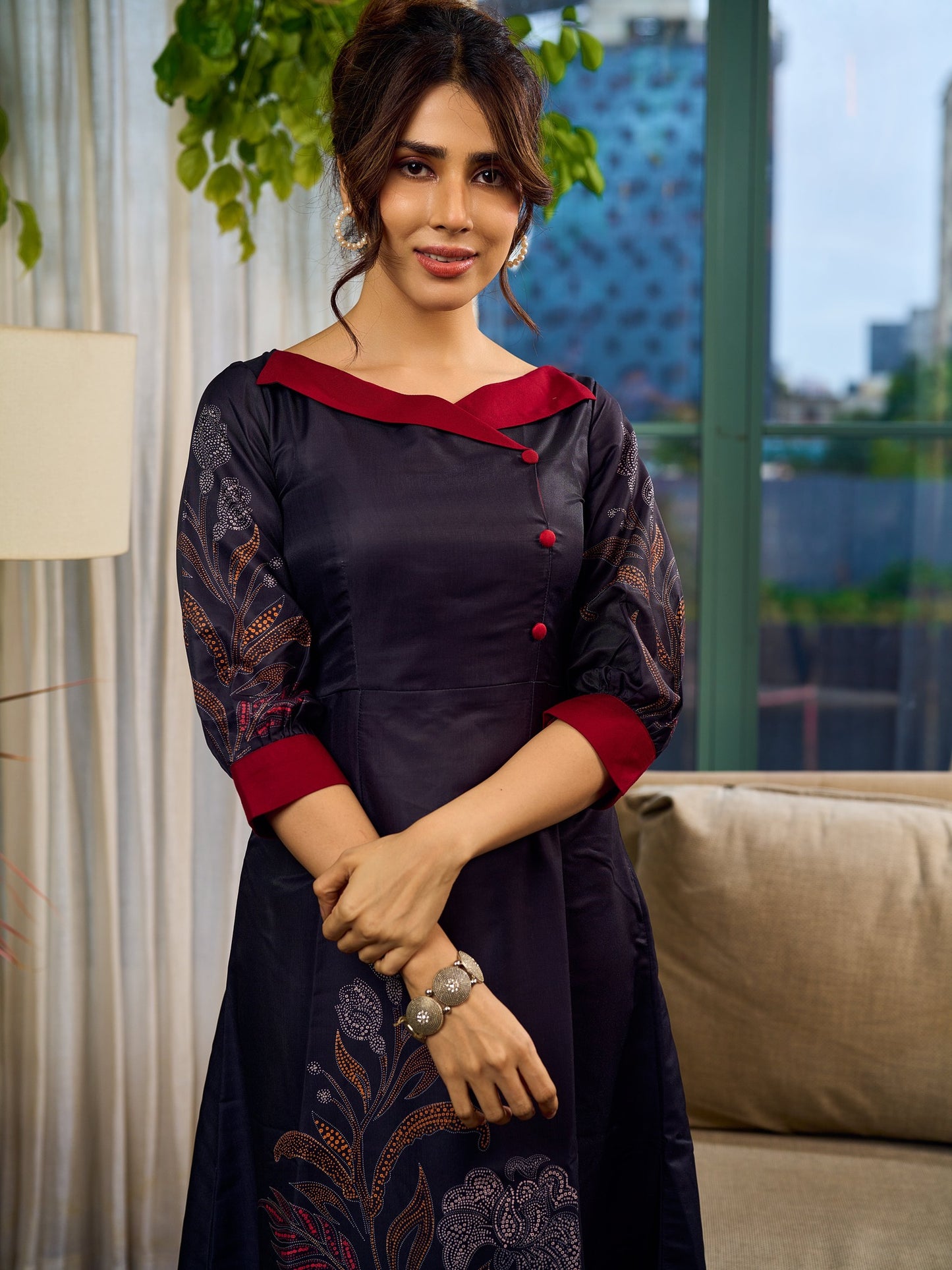 Elegant black Kalamkari-inspired dress with deep maroon accents and graceful floral motifs.
