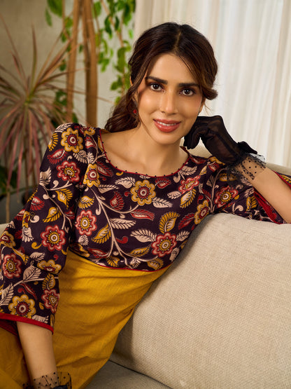Mustard Kalamkari dress with an asymmetrical yoke and puffed sleeves.
