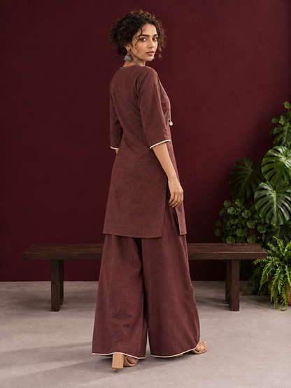 Brown Cotton Co-Ord Set with Contrast Cream Kantha Neckline & Cowrie Shell Tassels with Straight Fit Pant — in motion