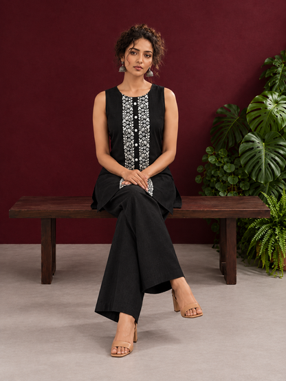 Elegant Black Cotton Sleeveless Coord with White Floral lace Front Placket & Buttons with black palazzo pants — seated