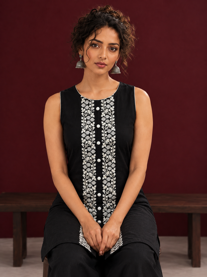 Elegant Black Cotton Sleeveless Coord with White Floral lace Front Placket & Buttons with black palazzo pants — seated detail
