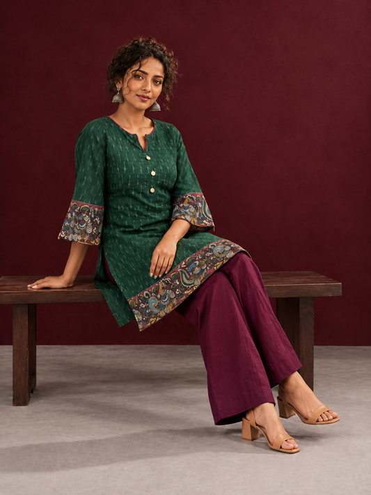 Bottle Green Ikat Cotton Co-Ord Set with Kalamkari Peacock Print Border on Sleeves and Hem with Maroon Farshi Collec — seated