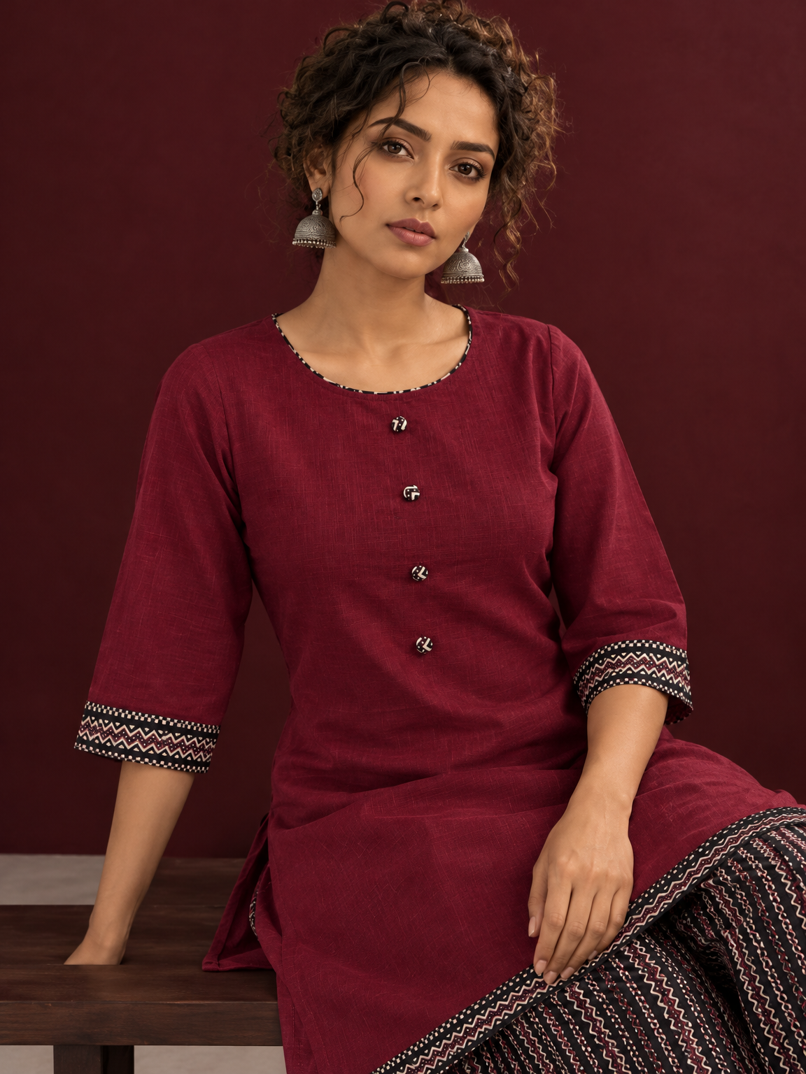 Timeless Maroon Ajrakh Cotton Co-Ord Set with Contrast Printed Border Tunic & Matching Geometric Pattern Fars — seated detail — view 7