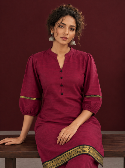 Elegant Maroon Silk Co-Ord Set with Contrast Black & Gold Border Detailing on Hem and Sleeves — seated detail
