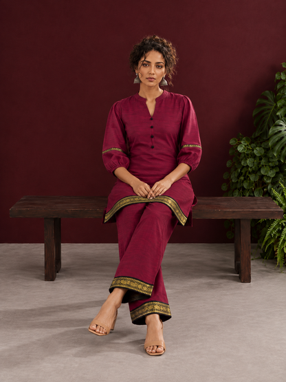 Elegant Maroon Silk Co-Ord Set with Contrast Black & Gold Border Detailing on Hem and Sleeves — seated