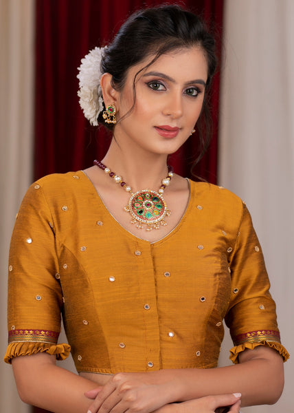 Exclusive metallic gold blouse with overall mirror embroidery highlighted with banarasi lace
