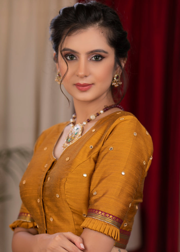 Exclusive metallic gold blouse with overall mirror embroidery highlighted with banarasi lace