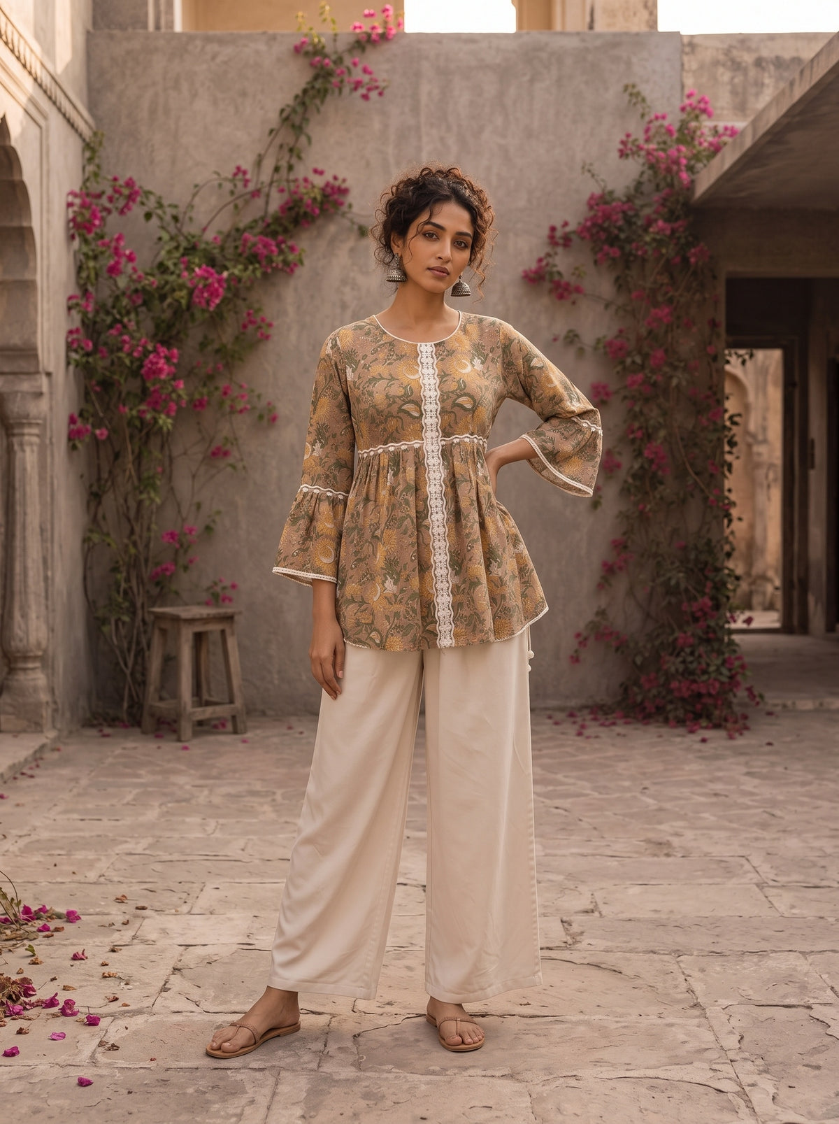 Romantic peach Jaipur floral top adorned with scalloped lace, gathered sleeve hems, and playful tie-knot accents.