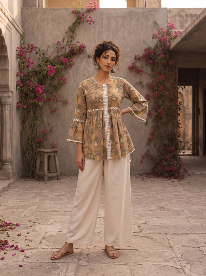 Romantic peach Jaipur floral top adorned with scalloped lace, gathered sleeve hems, and playful tie-knot accents.