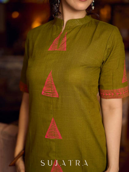 Gorgeous olive dress with pink abstract triangle hand block prints placed at the centre, sleeves, and back, featuring a mandarin collar and half sleeves for a refined, contemporary look.