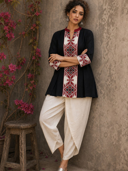 Heritage-inspired black top showcasing handcrafted block print panels, elegant maroon trims, and timeless artistry for versatile modern styling.