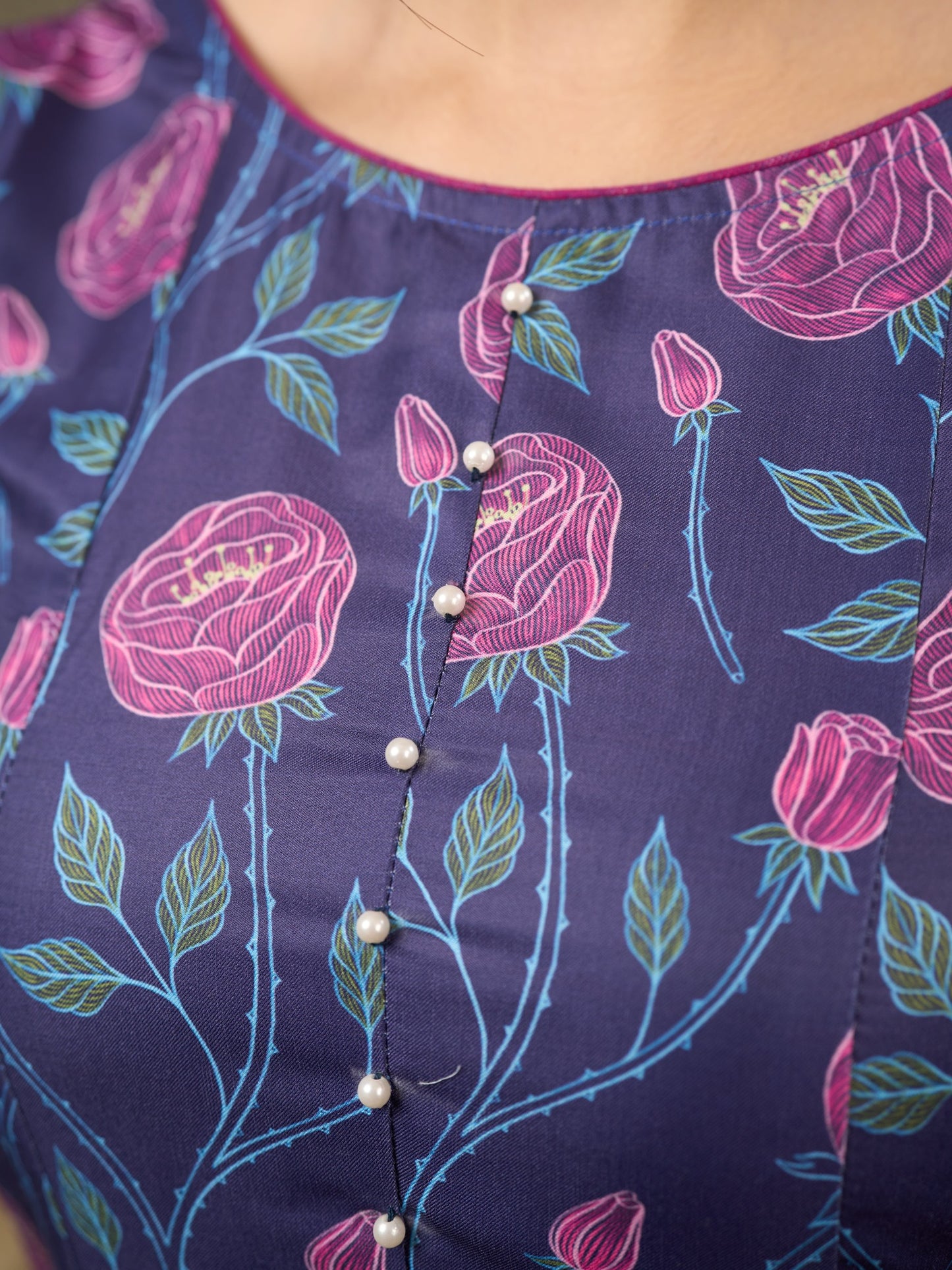 Enchanting purple panel dress featuring vibrant magenta floral prints, a sleeveless silhouette, and a graceful fit-and-flare design for timeless elegance.