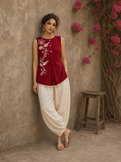 Charming red hand block print top showcasing elegant floral motifs, a contemporary pleated silhouette, and refined detailing, blending artisanal craftsmanship with effortless everyday style.