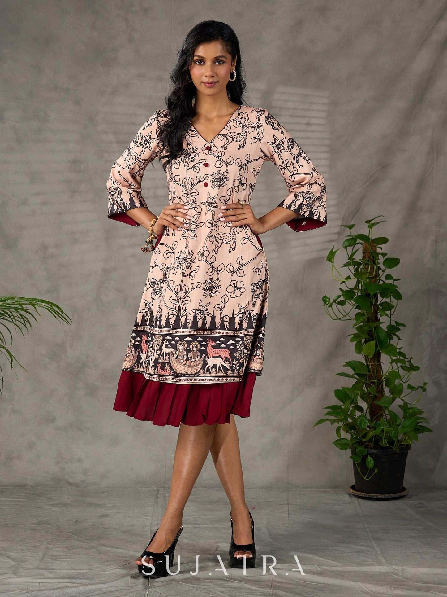 Beige traditional printed dress with rich maroon accents.