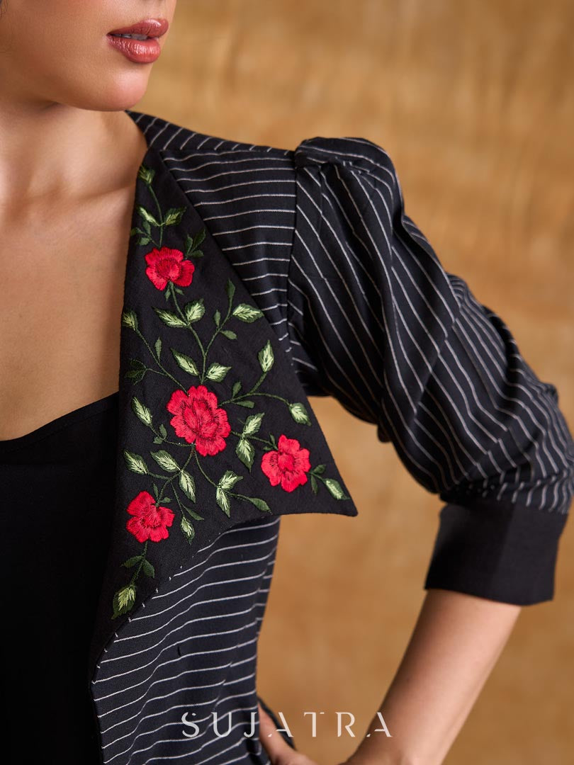 Exquisite black Ikat jacket with offset collar flaps and detailed red floral vine embroidery, delivering a sculpted, high-impact silhouette with refined presence for corporate styling.