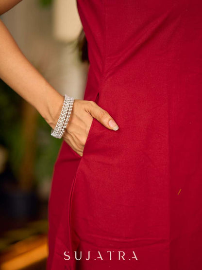 Maroon block printed sleeveless dress with hand block printed floral side panel, off-white accents, and pearl embellishments for a refined, elegant look.