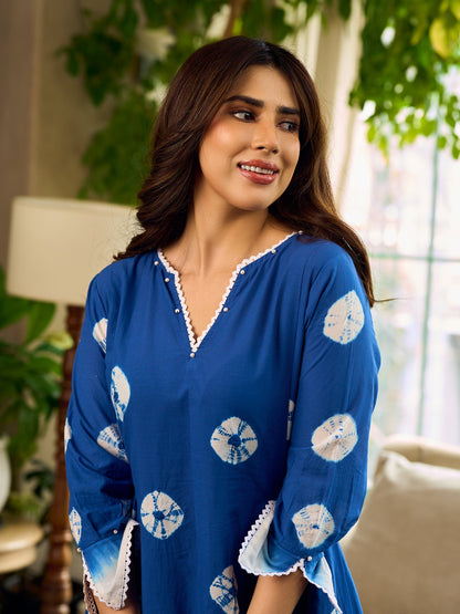 Refreshing cobalt blue shibori tie-dye dress with ivory accents and delicate lace-trimmed neckline.