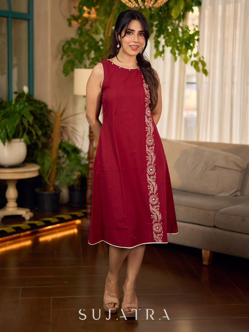 Maroon block printed sleeveless dress with hand block printed floral side panel, off-white accents, and pearl embellishments for a refined, elegant look.