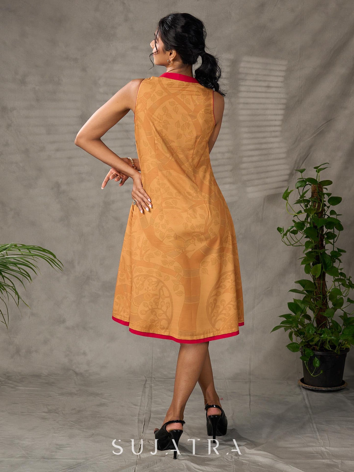 Mustard Gond printed mandarin collar dress with vibrant pink accents.